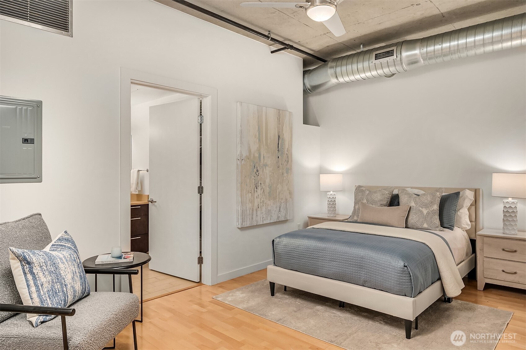 2720 3rd Avenue, Unit 909 Seattle, WA 98121 - Photo 13 of 40 a bedroom with a bed and a chair