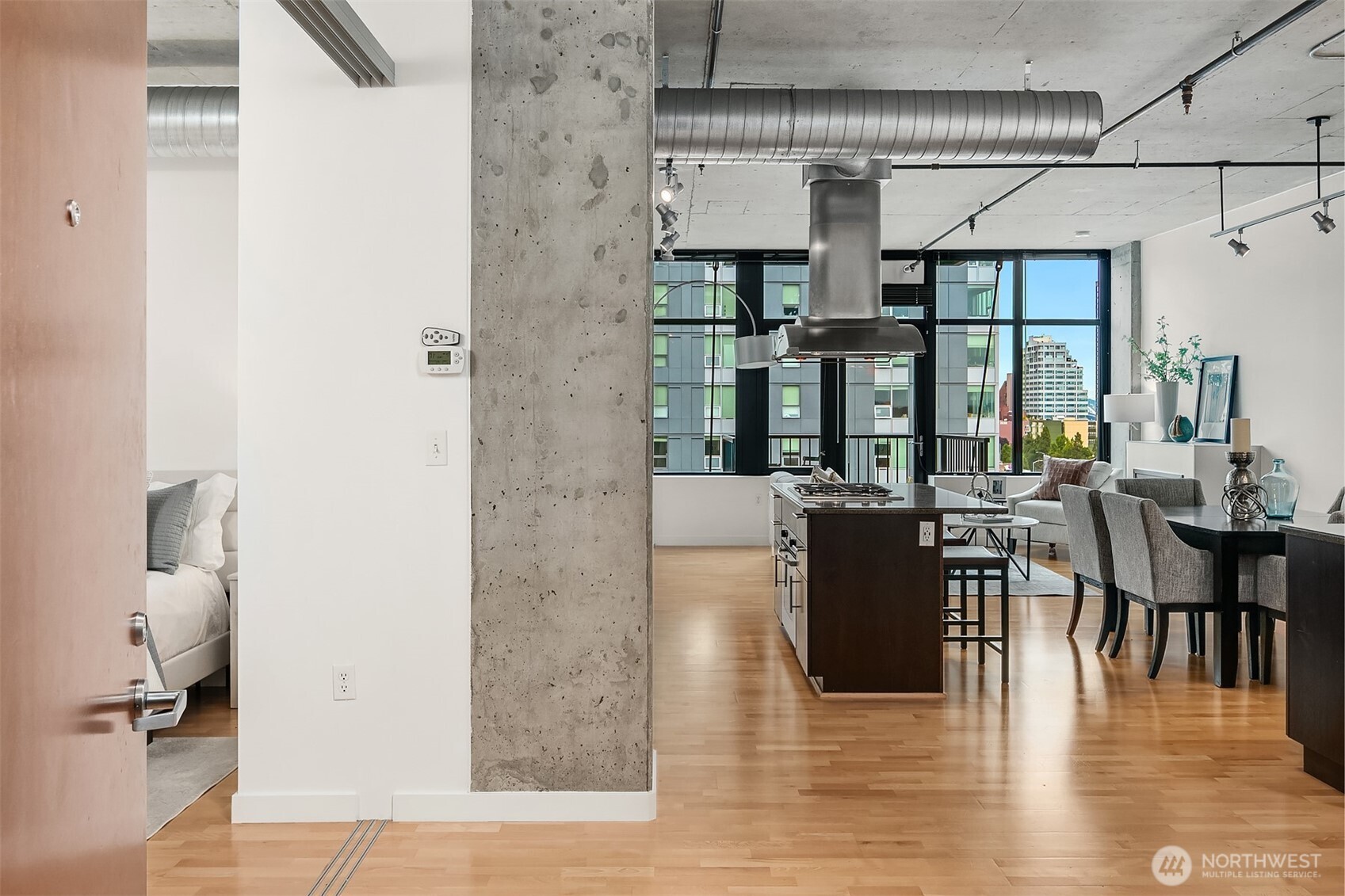 2720 3rd Avenue, Unit 909 Seattle, WA 98121 - Photo 14 of 40 an open kitchen with dining table and chairs