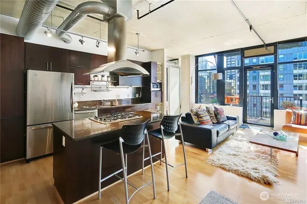 a kitchen with stainless steel appliances granite countertop a stove and a refrigerator