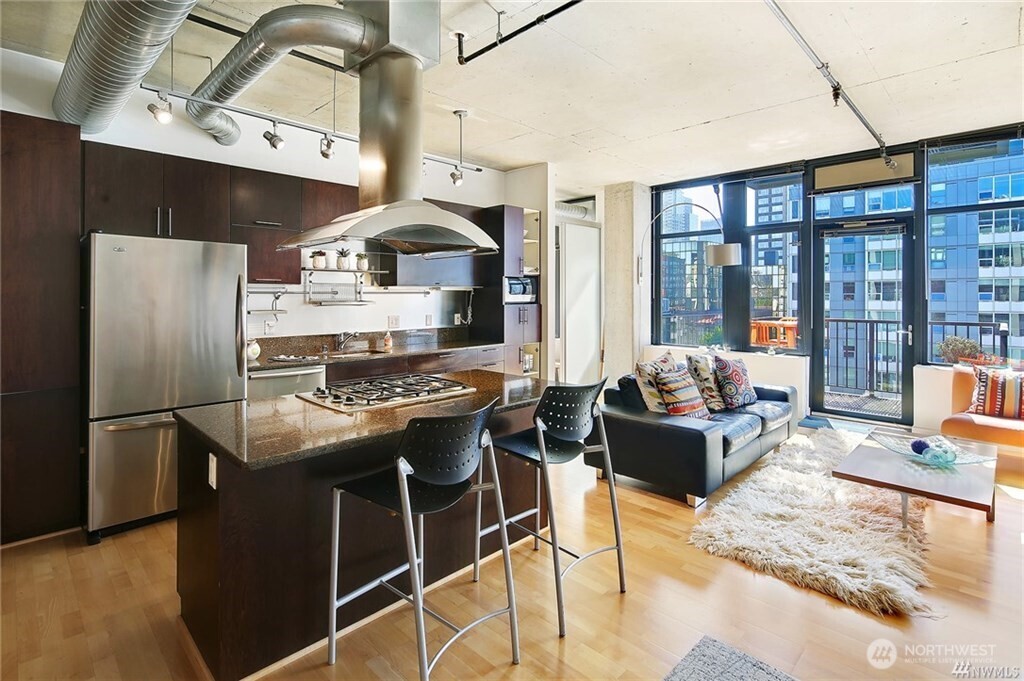 2720 3rd Avenue, Unit 909 Seattle, WA 98121 - Photo 16 of 40 a kitchen with stainless steel appliances granite countertop a stove and a refrigerator