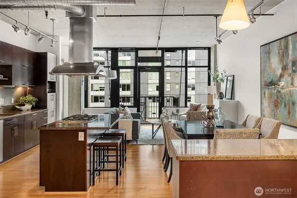 a living room with fireplace furniture and a large window