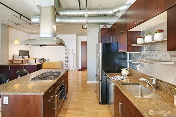 a kitchen with stainless steel appliances granite countertop a sink stove and refrigerator