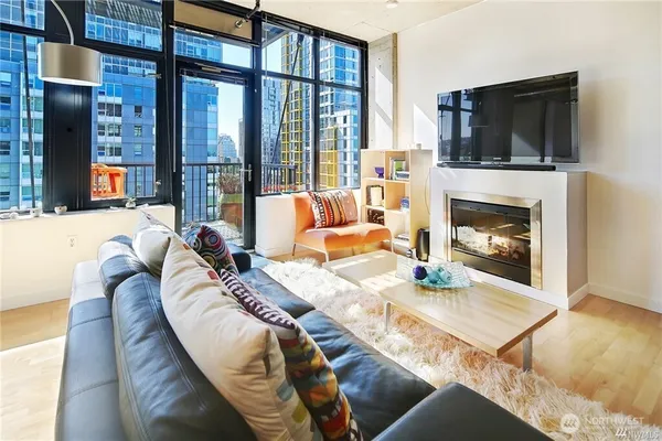 a living room with furniture fireplace and flat screen tv