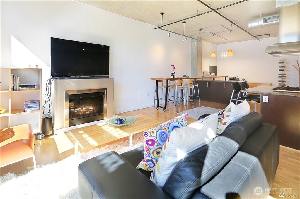 2720 3rd Avenue, Unit 909 Seattle, WA 98121 - Photo 20 of 40 a living room with furniture and a fireplace