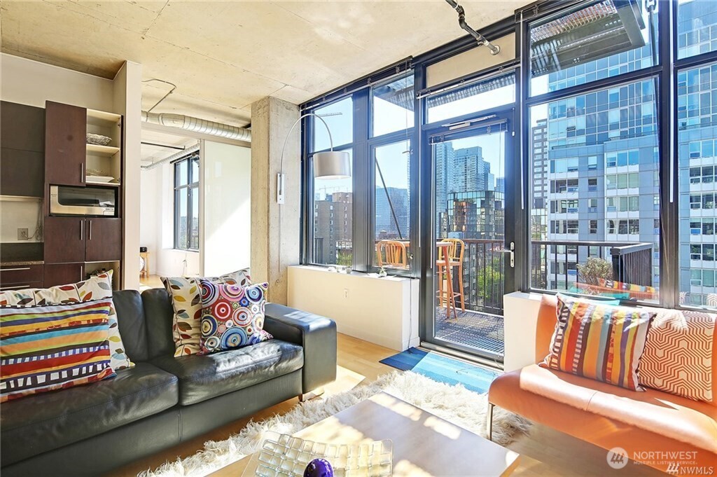 2720 3rd Avenue, Unit 909 Seattle, WA 98121 - Photo 22 of 40 a living room with furniture and a floor to ceiling window