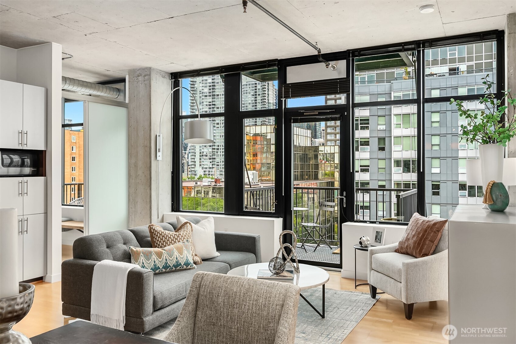 2720 3rd Avenue, Unit 909 Seattle, WA 98121 - Photo 23 of 40 a living room with furniture and large windows