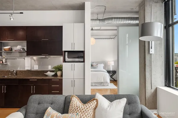 a kitchen with stainless steel appliances kitchen island granite countertop a refrigerator and a stove top oven