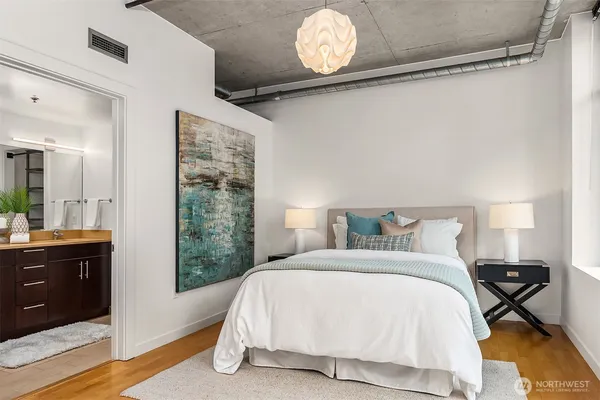 a bedroom with a bed and lamps