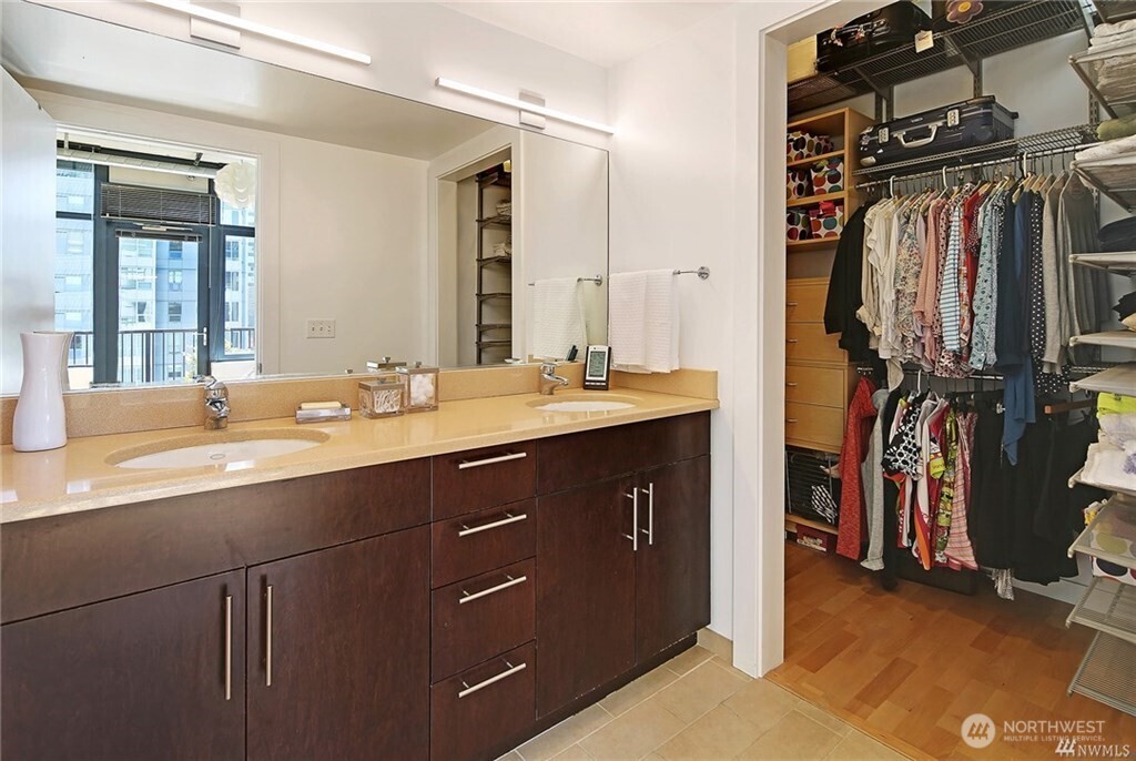2720 3rd Avenue, Unit 909 Seattle, WA 98121 - Photo 29 of 40 a bathroom with a sink double vanity and a mirror