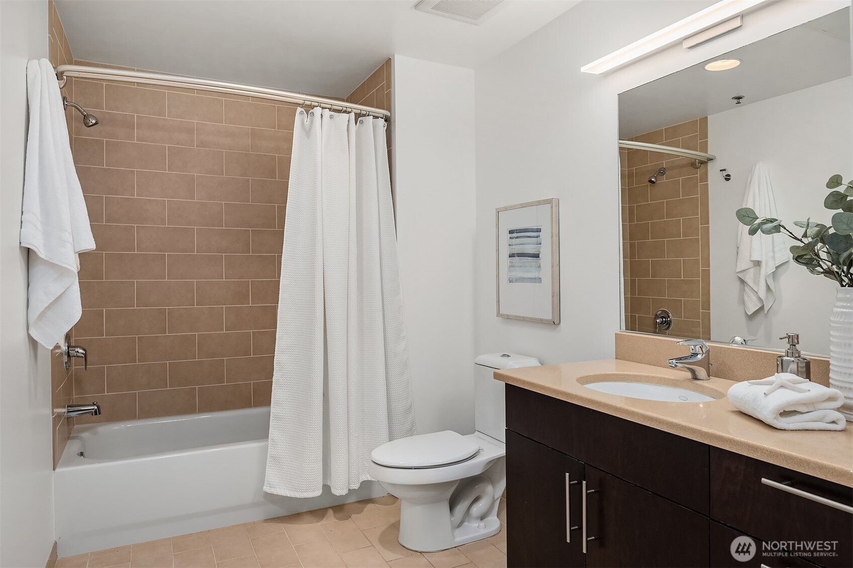 2720 3rd Avenue, Unit 909 Seattle, WA 98121 - Photo 33 of 40 a bathroom with a sink a toilet and shower