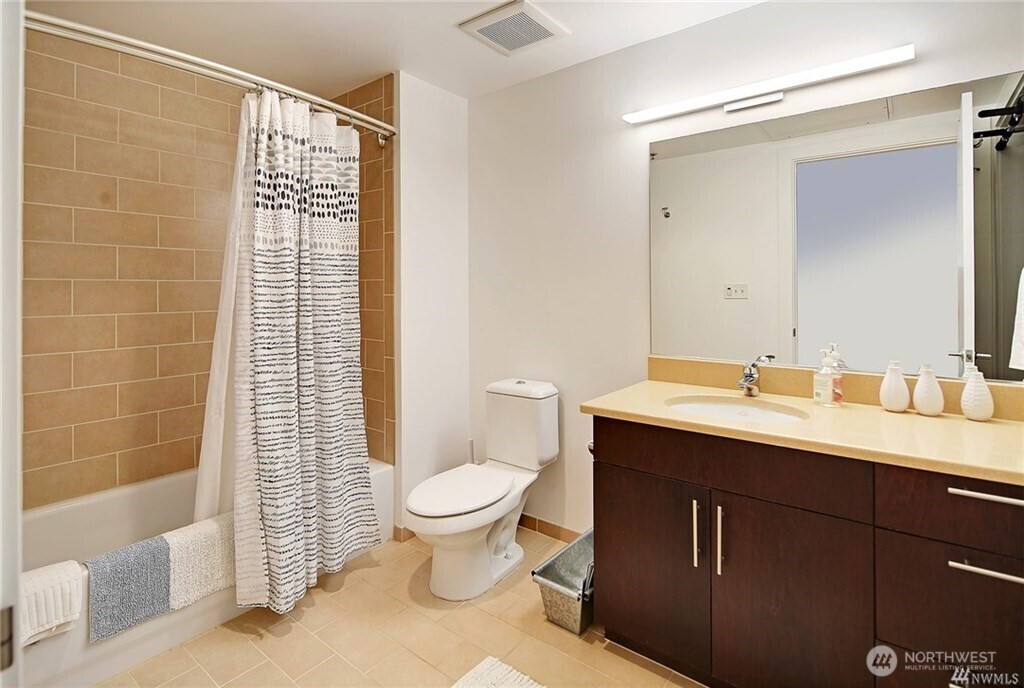 2720 3rd Avenue, Unit 909 Seattle, WA 98121 - Photo 34 of 40 a bathroom with a sink toilet and shower