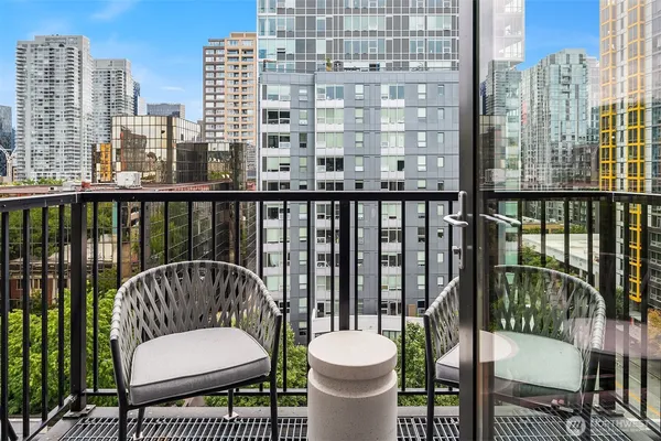 a view of a balcony with a potted plant and outdoor space