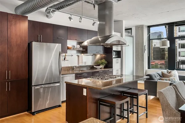 a kitchen with stainless steel appliances granite countertop a refrigerator and a stove