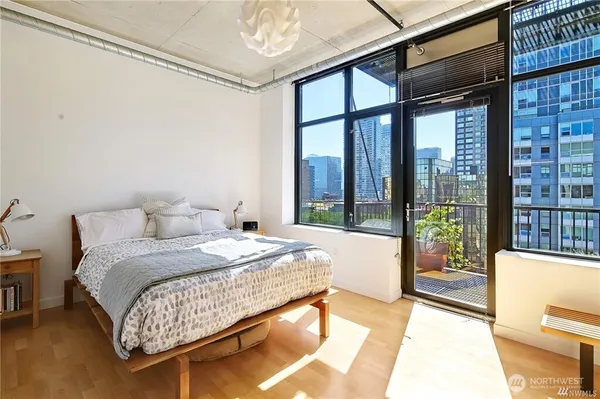 a bedroom with a large bed and a large window