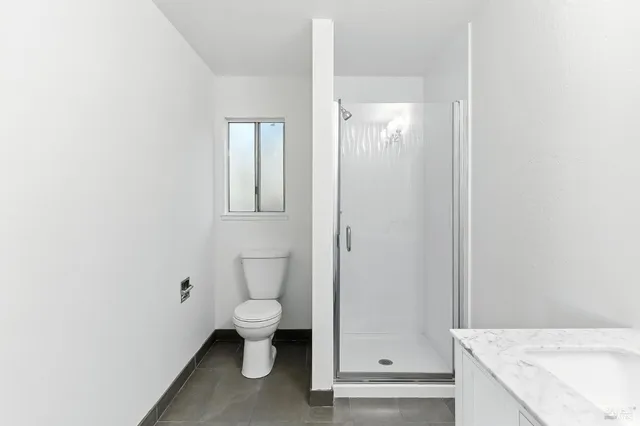 an empty room with wooden floor and window