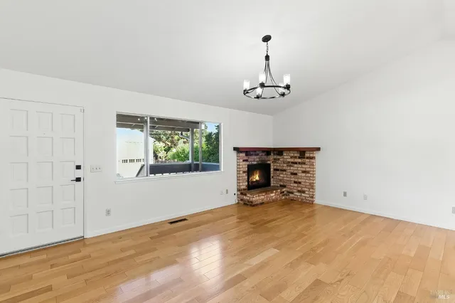 a view of empty room with a fireplace