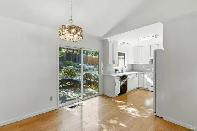 a view of a room with wooden floor and window