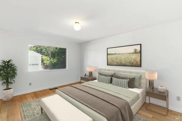 a bedroom with a bed and a painting on the wall