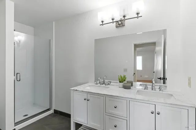 a bathroom with a double vanity sink and a mirror