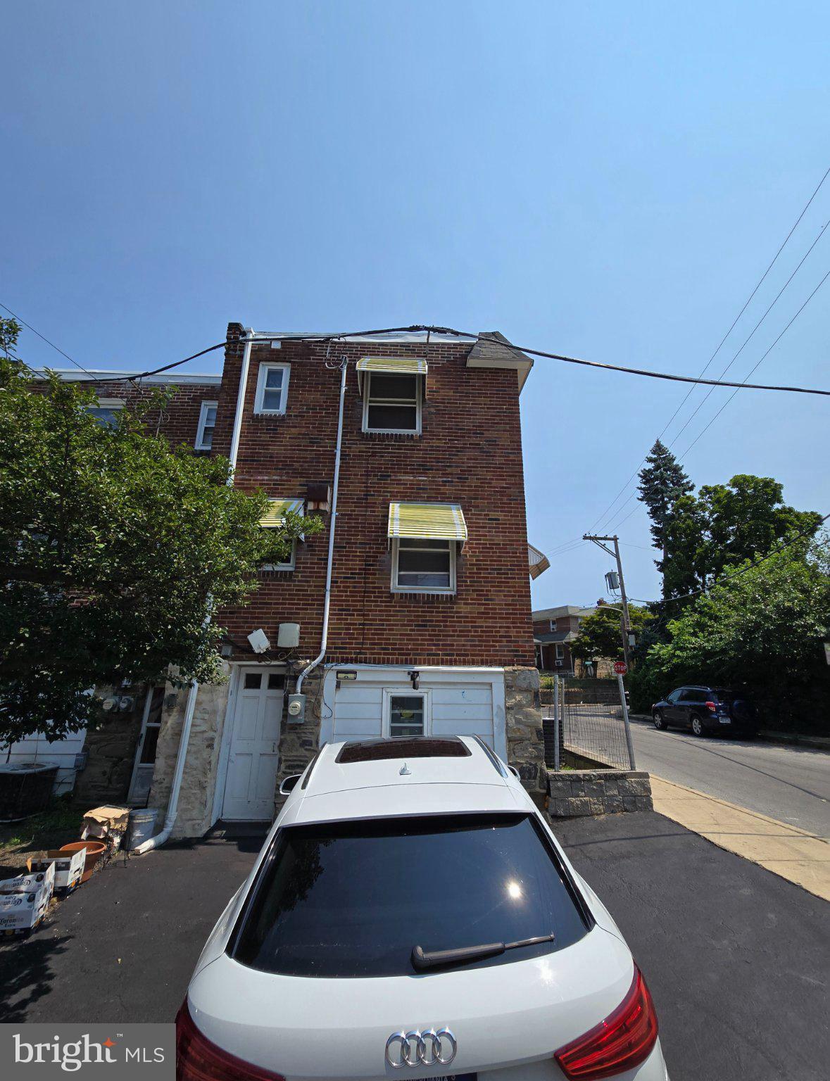 300 Springton Road Upper Darby, PA 19082 - Photo 15 of 19 Charming brick home under clear skies.