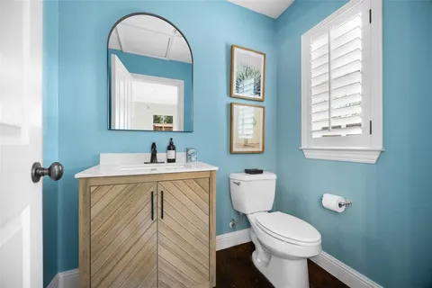 a bathroom with a sink a toilet and a window