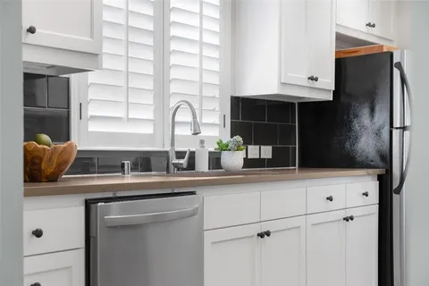 a kitchen with stainless steel appliances a sink and a refrigerator