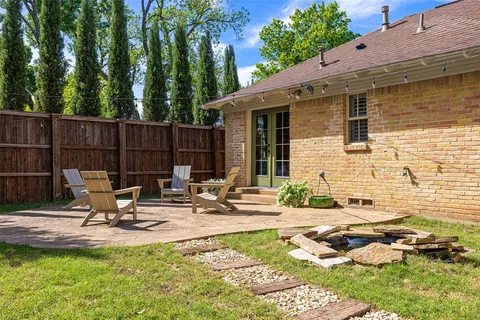 a dining room with furniture and a potted plant