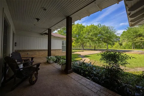 a view of a chairs and table in the balcony