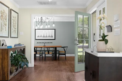 a view of a dining room with furniture and a potted plant