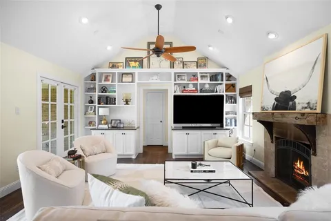 a living room with furniture a flat screen tv and a fireplace