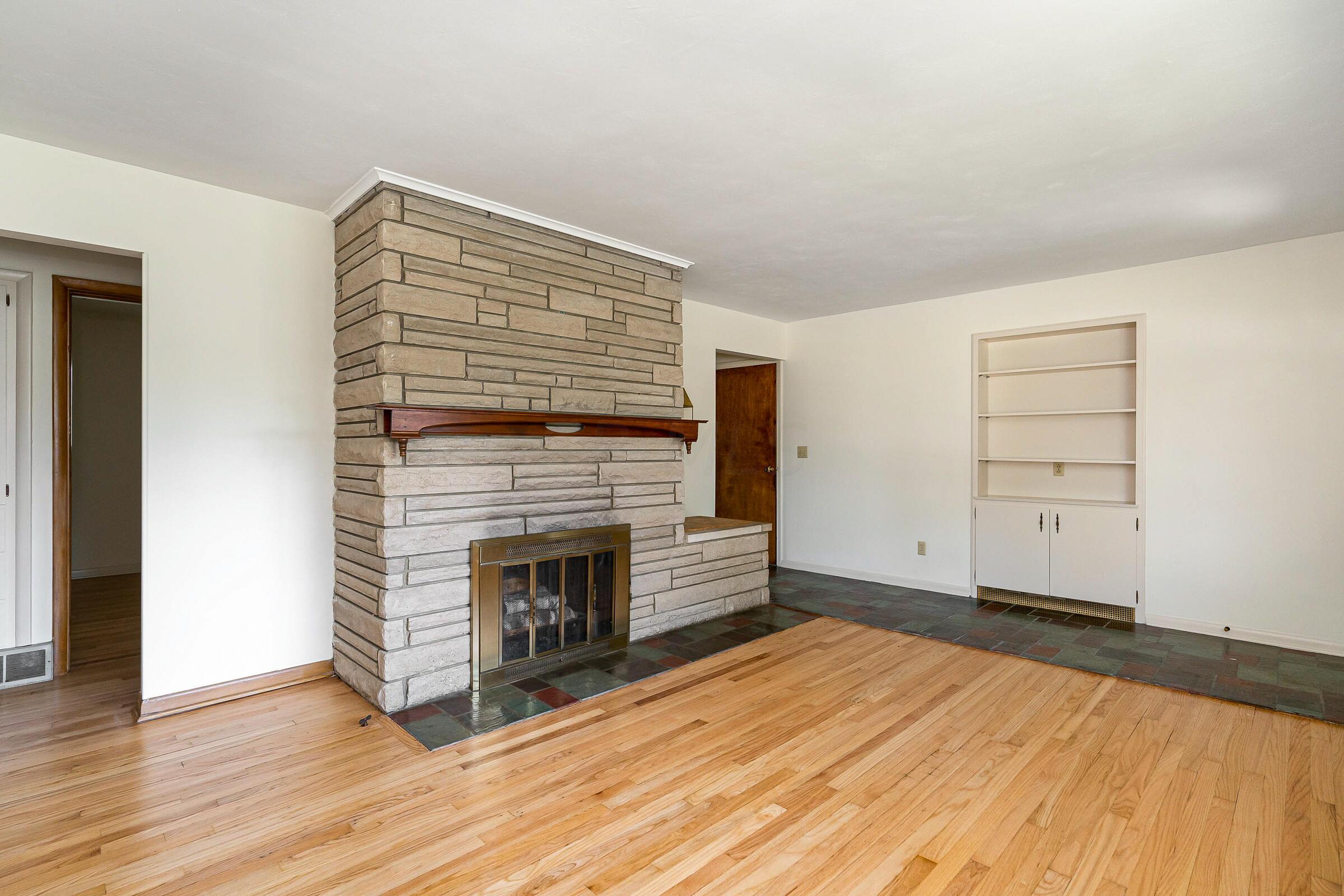 1017 Fordham Road Columbus, OH 43224 - Photo 6 of 30 A handsome floor-to-ceiling stone fireplace with wood mantel is featured in the living room