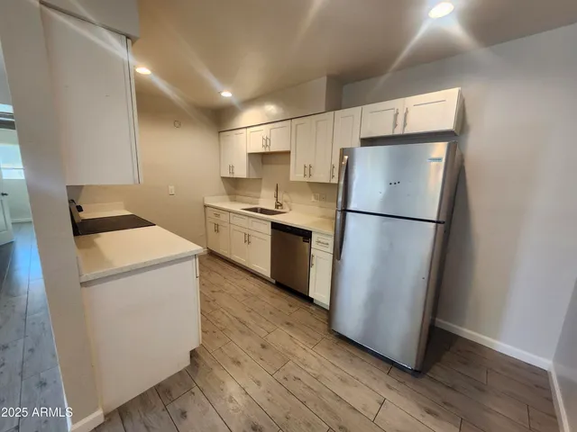 a kitchen with a refrigerator a stove top oven and a refrigerator