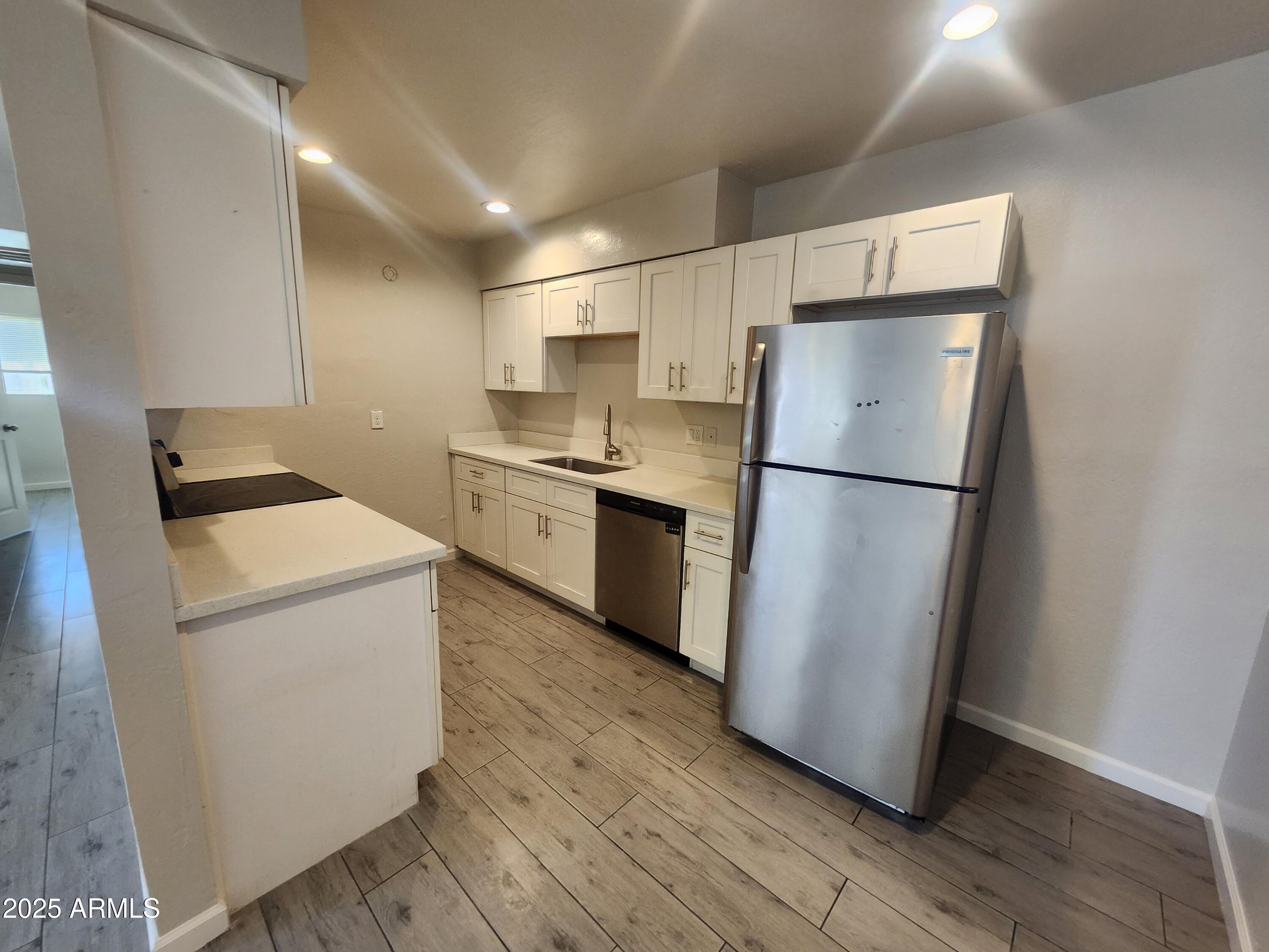a kitchen with a refrigerator a stove top oven and a refrigerator