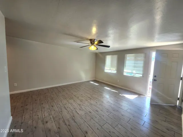 wooden floor in an empty room with a window