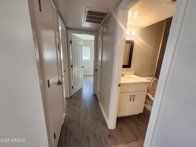 a view of hallway with wooden floor