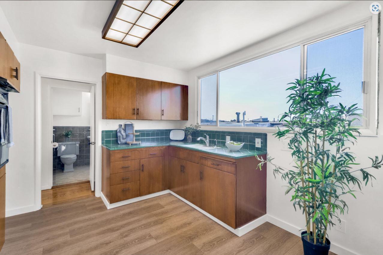 58 Pinehaven Drive Daly City, CA 94015 - Photo 13 of 38 a kitchen with stainless steel appliances a counter space and a living room