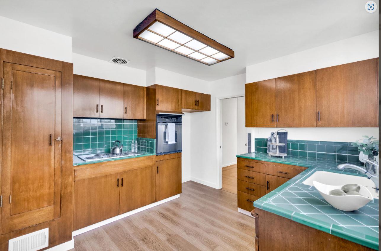 58 Pinehaven Drive Daly City, CA 94015 - Photo 14 of 38 a kitchen with granite countertop a sink a stove and wooden cabinets