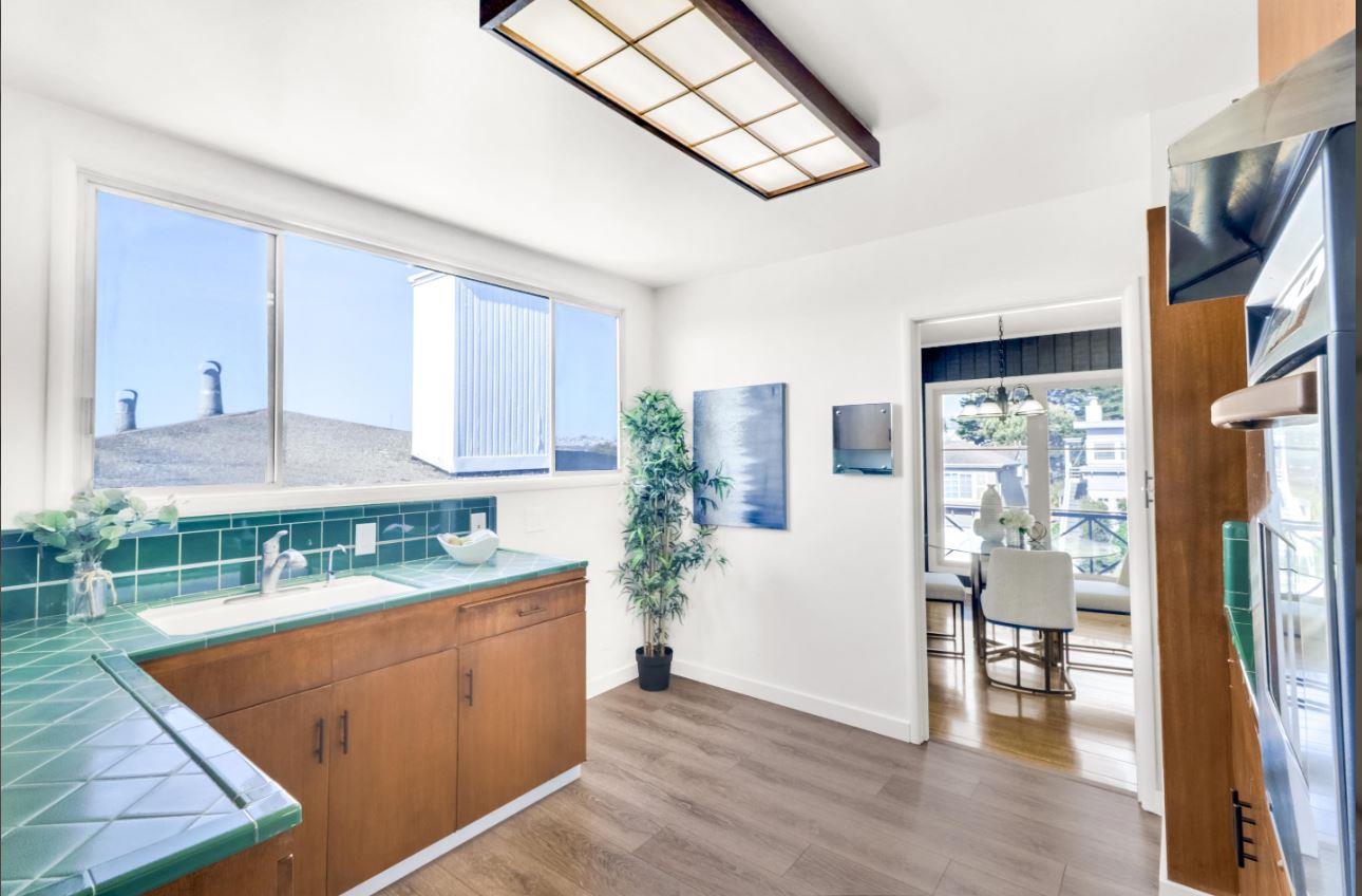 58 Pinehaven Drive Daly City, CA 94015 - Photo 15 of 38 a kitchen with stainless steel appliances granite countertop a refrigerator a stove and a wooden cabinets