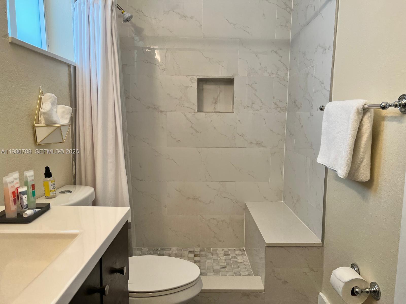 1736 Southwest 3rd Street, Unit 1 Miami, FL 33135 - Photo 4 of 6 a bathroom with a sink a toilet and shower