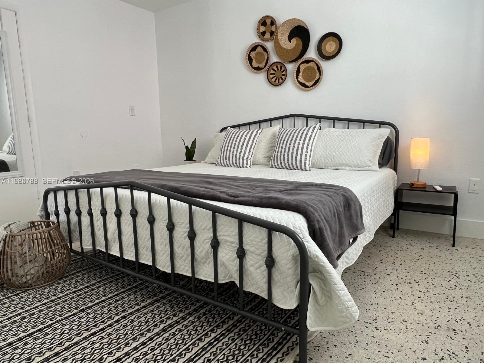 1736 Southwest 3rd Street, Unit 1 Miami, FL 33135 - Photo 5 of 6 a bedroom with a bed and wooden floor