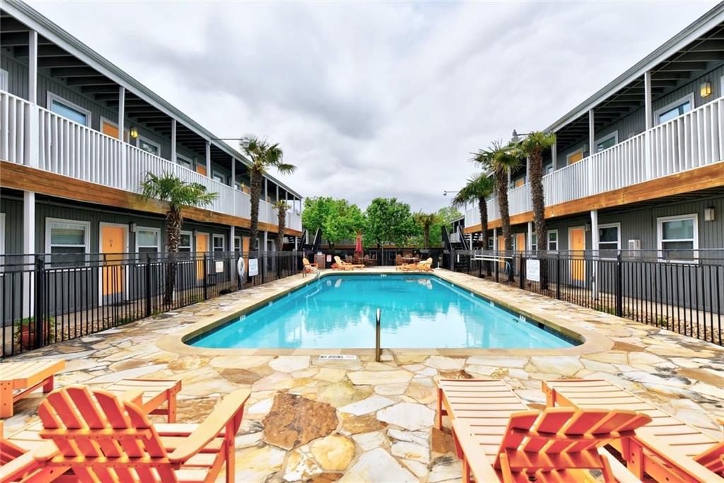 2401 Manor Road, Unit 102 Austin, TX 78722 - Photo 9 of 22 Community pool featuring a patio area and a balcony