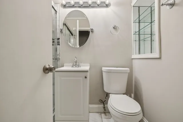 a white toilet sitting next to a bathroom sink