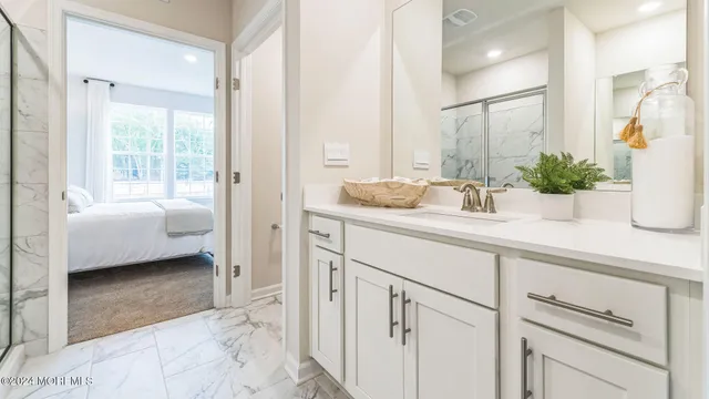 a en suite bathroom with sink and mirror