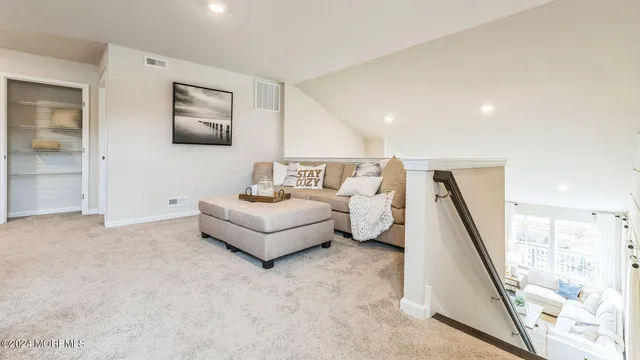 a living room with furniture and a painting on the wall