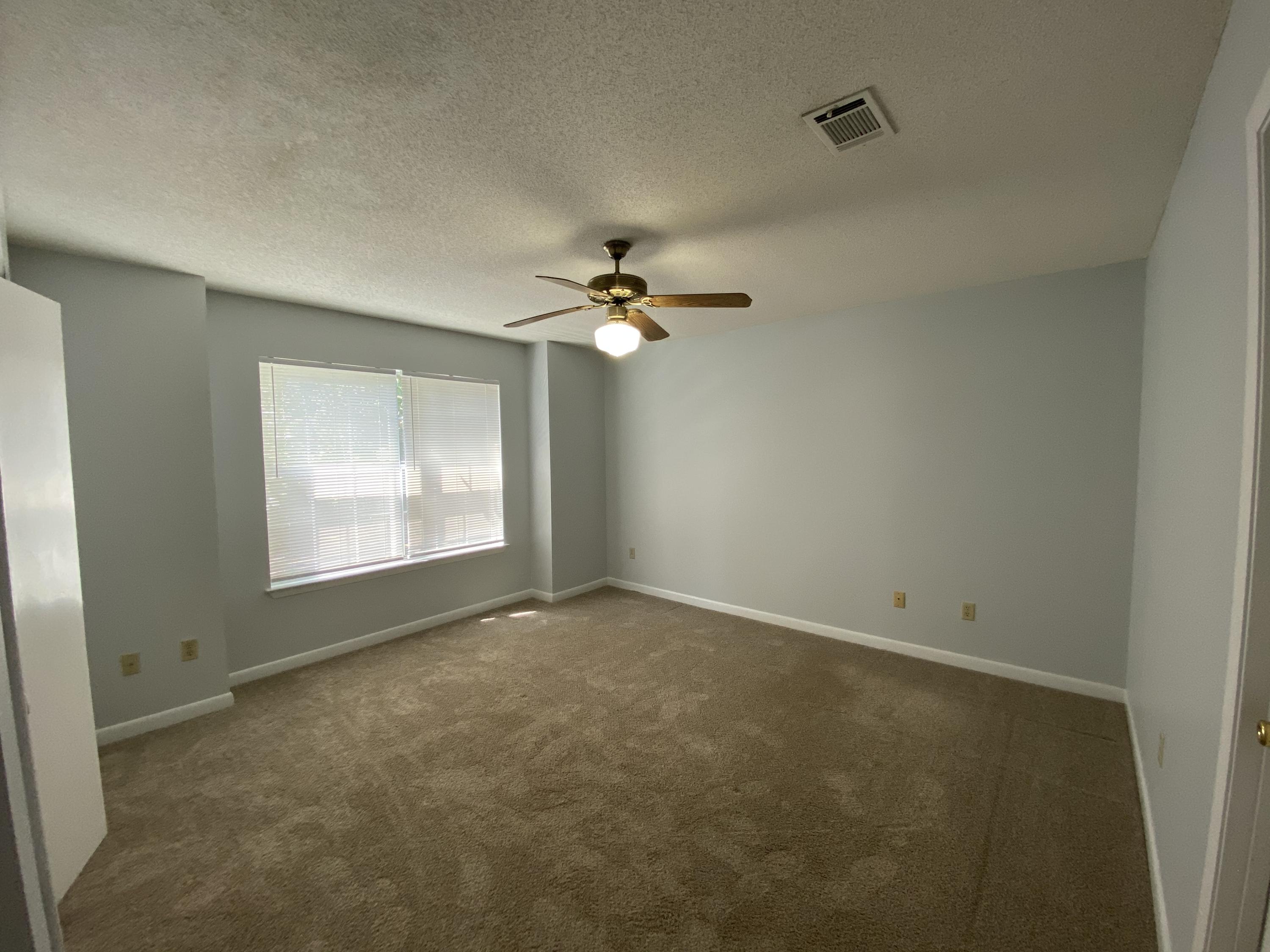 169 Wright Circle Niceville, FL 32578 - Photo 11 of 27 a view of a livingroom with a ceiling fan and window
