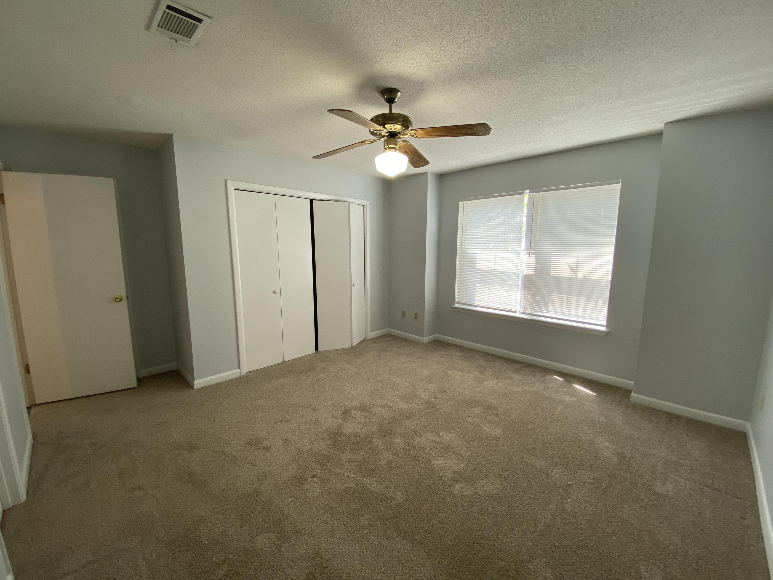 169 Wright Circle Niceville, FL 32578 - Photo 12 of 27 an empty room with windows and fan