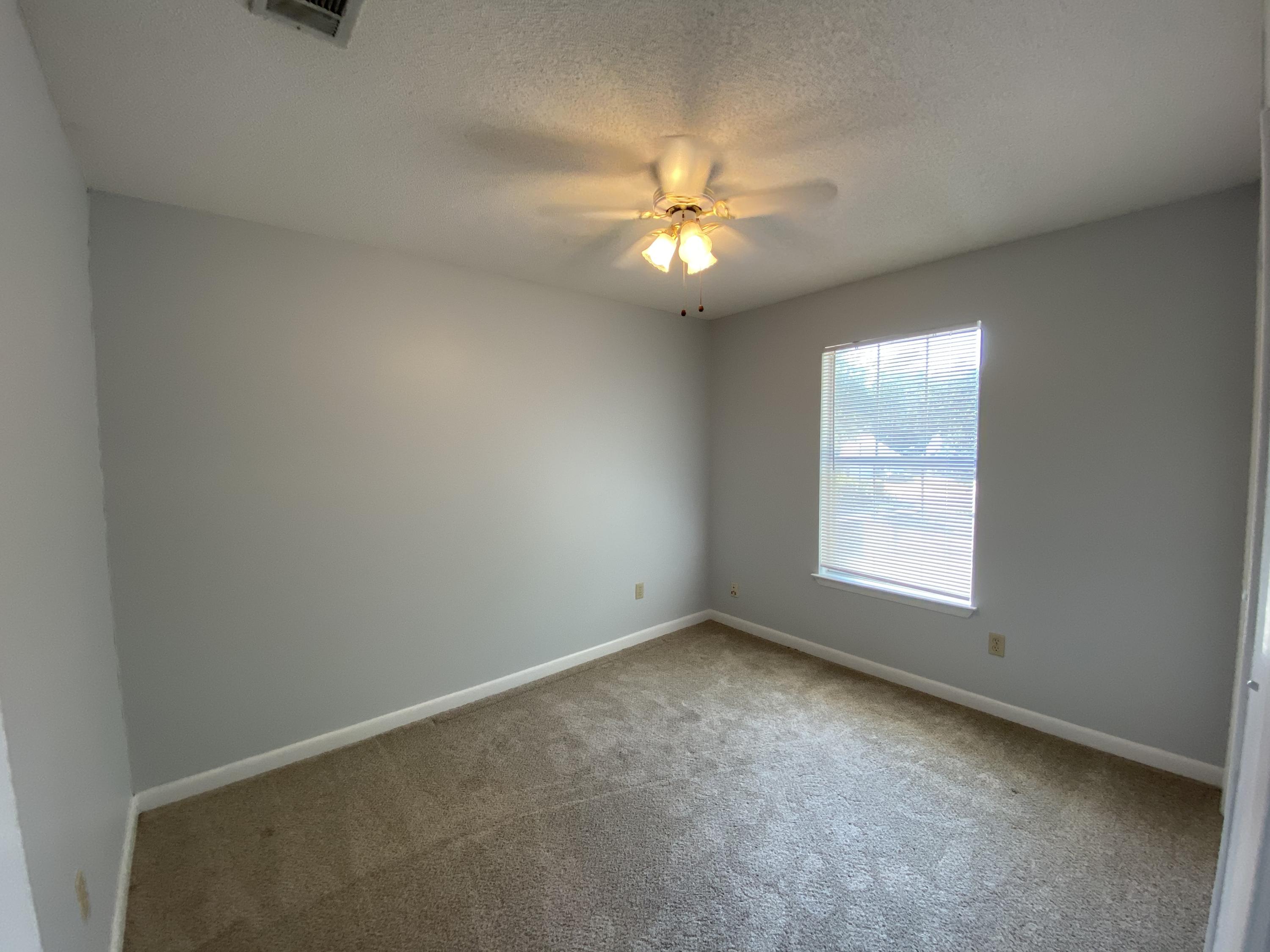 169 Wright Circle Niceville, FL 32578 - Photo 19 of 27 an empty room with a window and a fan