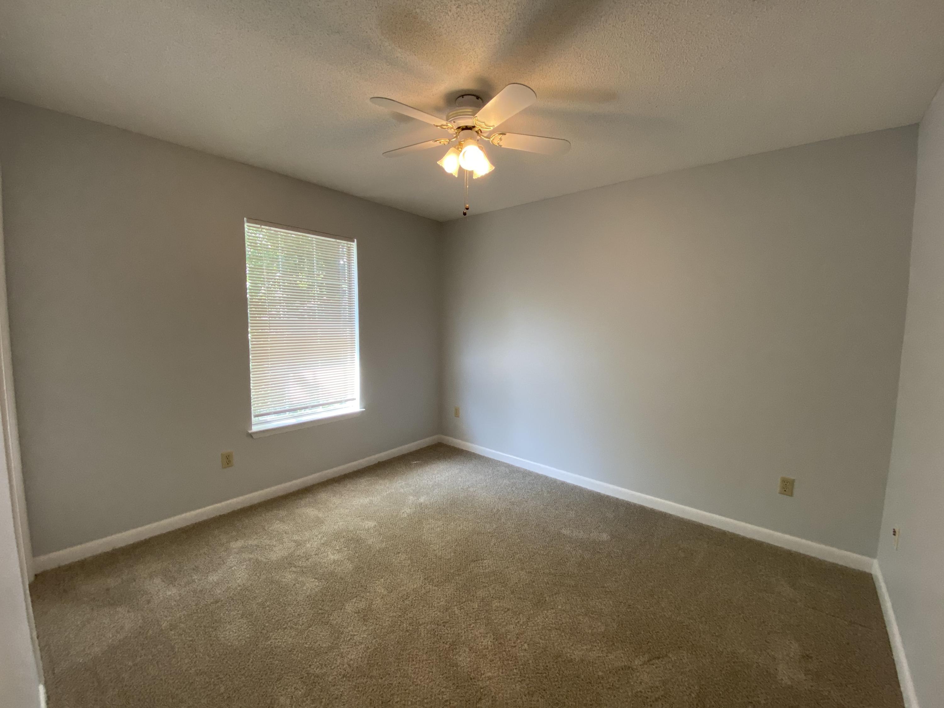 169 Wright Circle Niceville, FL 32578 - Photo 24 of 27 an empty room with a window and a ceiling fan