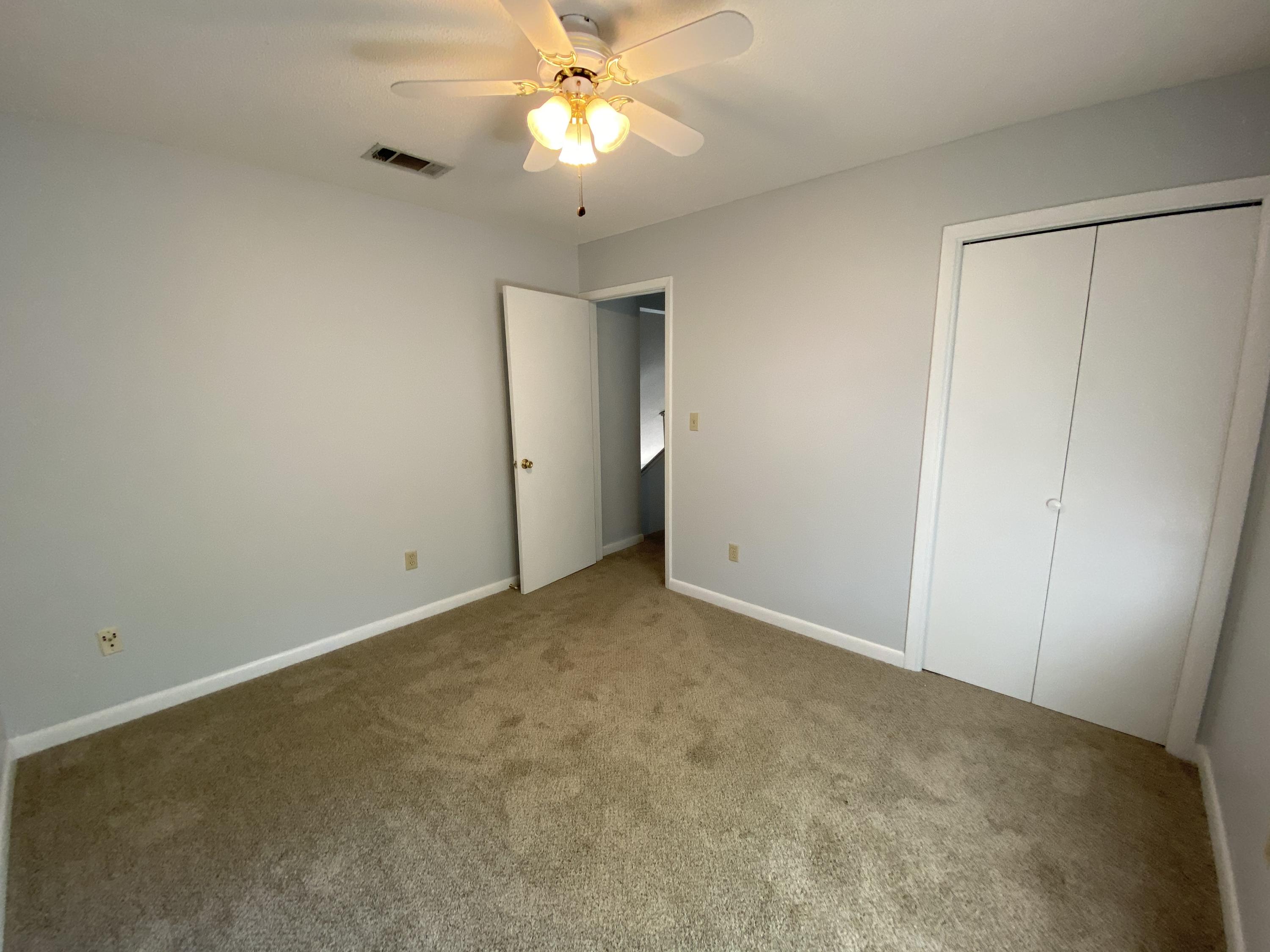 169 Wright Circle Niceville, FL 32578 - Photo 26 of 27 an empty room with a chandelier fan and closet area