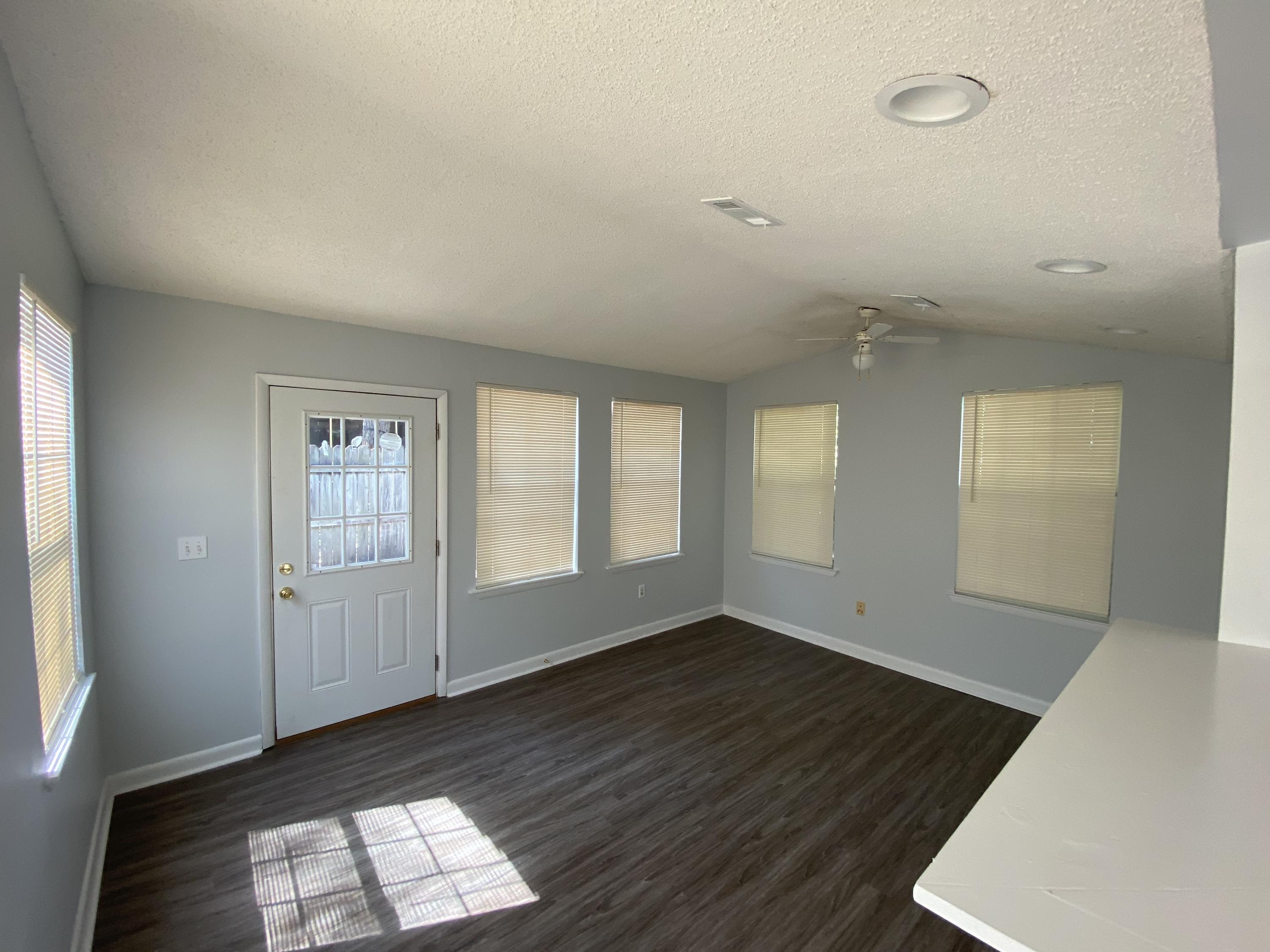 169 Wright Circle Niceville, FL 32578 - Photo 7 of 27 an empty room with wooden floor and windows
